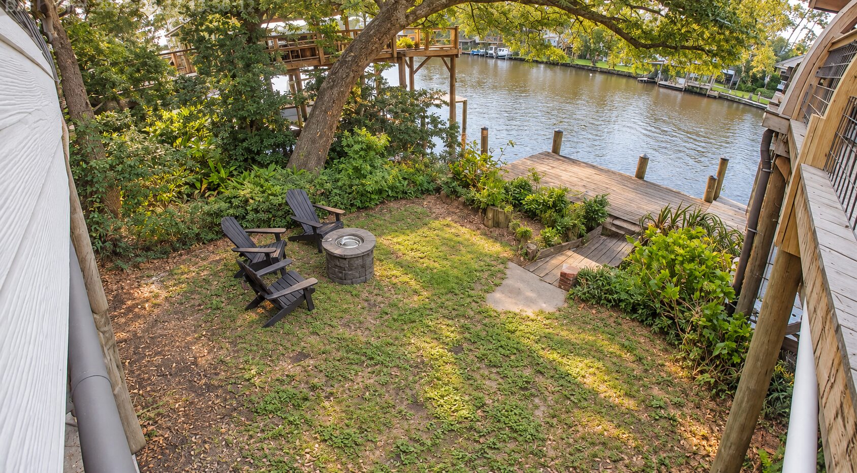 Backyard fire pit, Adirondack chairs, garden, and private dock on Fish River