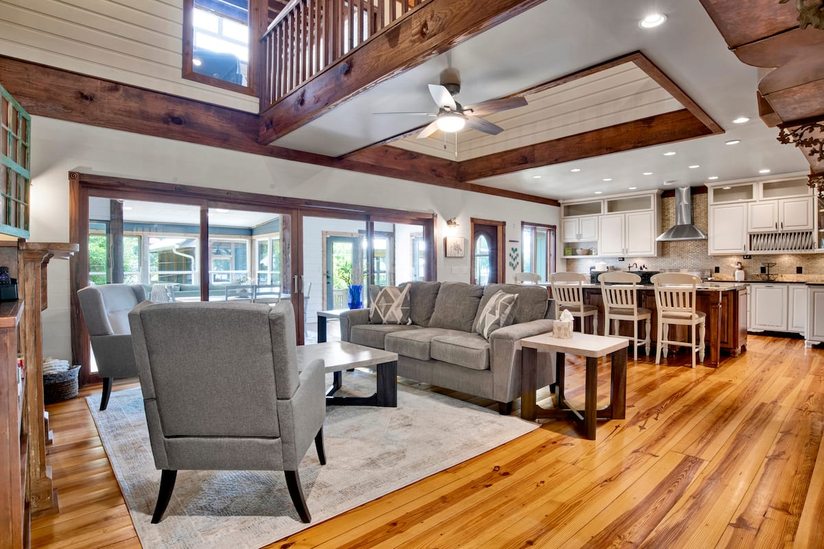Open living room and full kitchen inside the Catican Bayou vacation rental